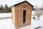 Angled front view of the Dundalk CT Granby 3-Person Outdoor Cabin Sauna in the snow