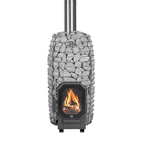 Huum Hive Flow Mini 8.5kW wood-burning sauna stove with stacked sauna stones, chimney pipe and fire burning