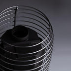 Close-up of the stainless steel stone cage and chimney connection on the Huum Hive Wood 13kW wood-burning sauna stove