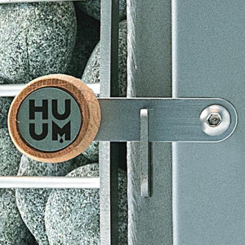 Close-up of Huum branding on the Huum Hive Wood LS 17kW wood-burning sauna stove with sauna stones