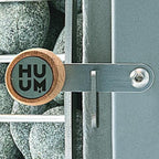 Close-up of Huum branding on the Huum Hive Wood LS 17kW wood-burning sauna stove with sauna stones