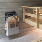 Harvia The Wall 8kW electric sauna heater installed in a sauna beside a wooden railing