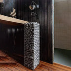 Huum Cliff 9kW Sauna Heater in a dark sauna with wooden floor