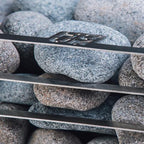Close-up of the Huum logo and sauna stones on the Huum Cliff 10.5kW Sauna Heater