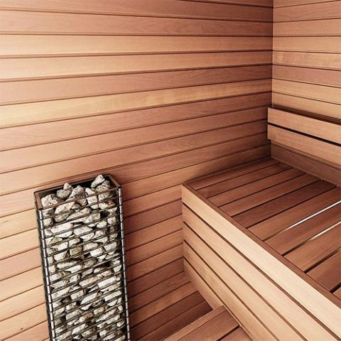 Huum Cliff Mini 3.5kW Sauna Heater in a cedar sauna with bench