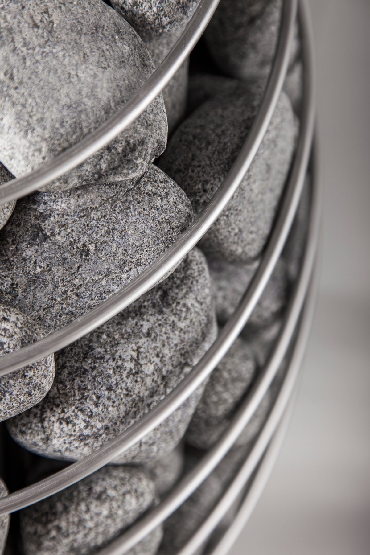 Close-up of the stone cage and sauna stones on the Huum Drop 6kW Sauna Heater