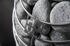 Close-up of the Huum logo and sauna stones on the Huum Drop 4.5kW Sauna Heater