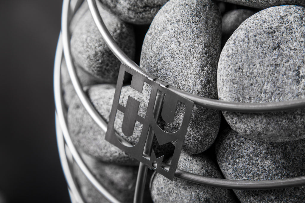 Close-up of the Huum logo and sauna stones on the Huum Drop 9kW Sauna Heater