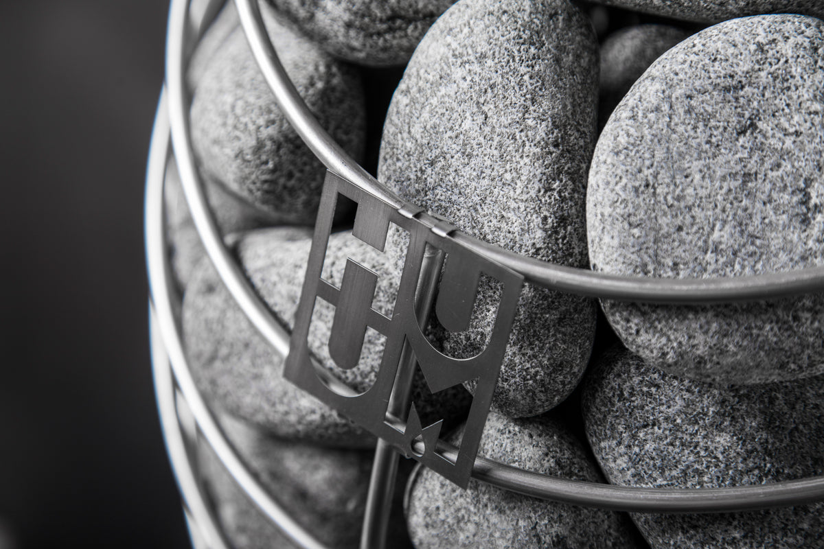 Close-up of the Huum logo and sauna stones on the Huum Drop 9kW Sauna Heater