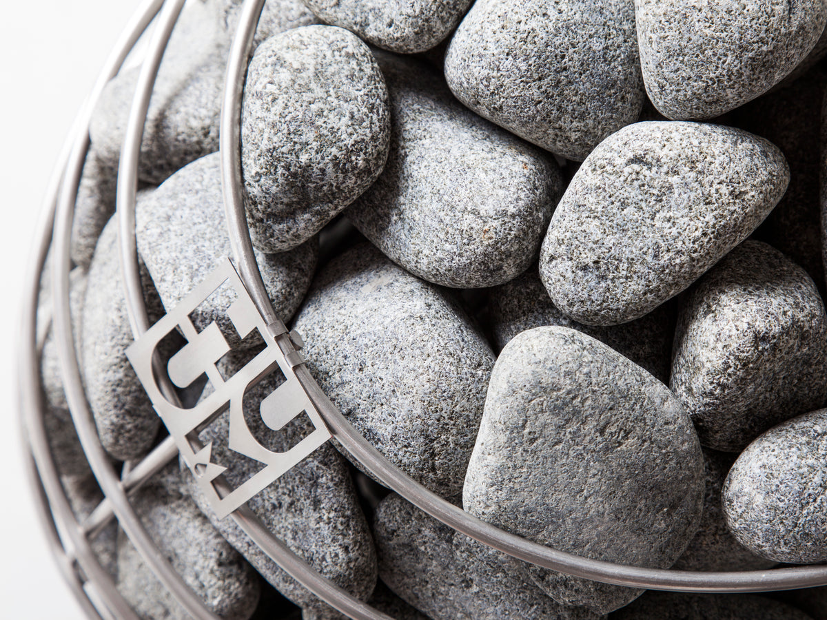 Close-up of the stone cage with Huum logo on the Huum Drop 9kW Sauna Heater