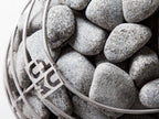 Close-up of the stone cage with Huum logo on the Huum Drop 6kW Sauna Heater