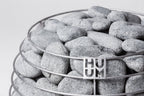 Close-up of the Huum logo on the stone cage of the Huum Hive 15kW Sauna Heater