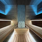 Huum Hive 18kW Sauna Heater in a sauna with blue ceiling lighting