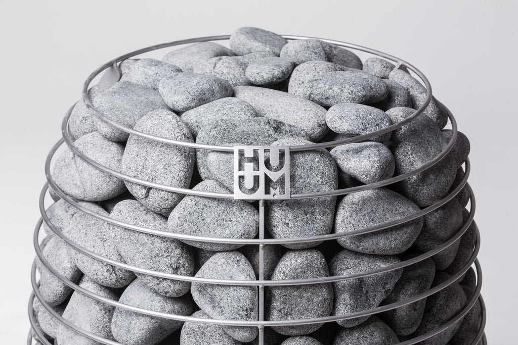 Close-up of the Huum logo and sauna stones on the Huum Hive 18kW Sauna Heater
