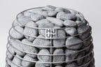 Close-up of the Huum logo and sauna stones on the Huum Hive 18kW Sauna Heater