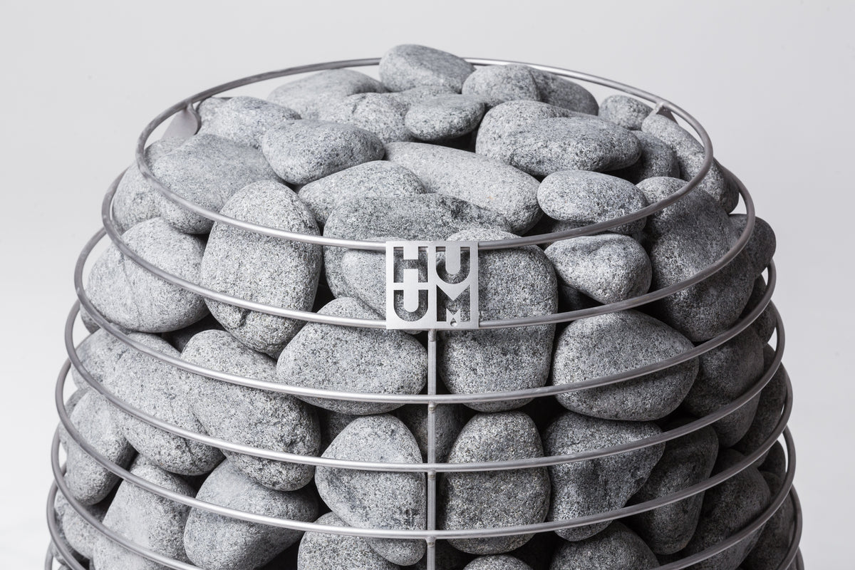 Close-up of the Huum logo and sauna stones on the Huum Hive 18kW Sauna Heater