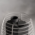 Close-up of the stainless steel stone cage and chimney connection on the Huum Hive Flow LS 9.8kW wood-burning sauna stove