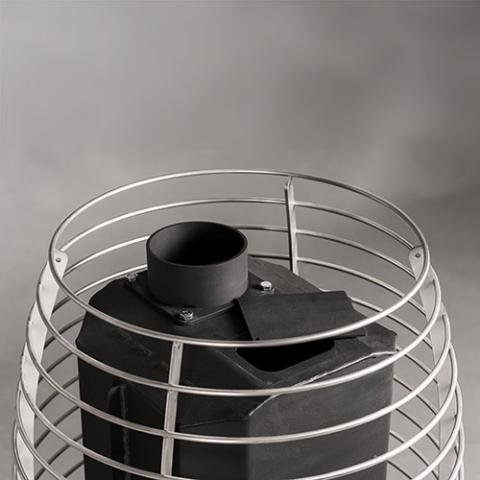 Close-up of the stainless steel stone cage and chimney connection on the Huum Hive Flow LS 9.8kW wood-burning sauna stove