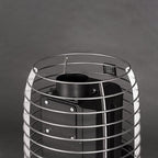 Close-up of the stainless steel stone cage and chimney connection on the Huum Hive Flow Mini LS 8.5kW wood-burning sauna stove