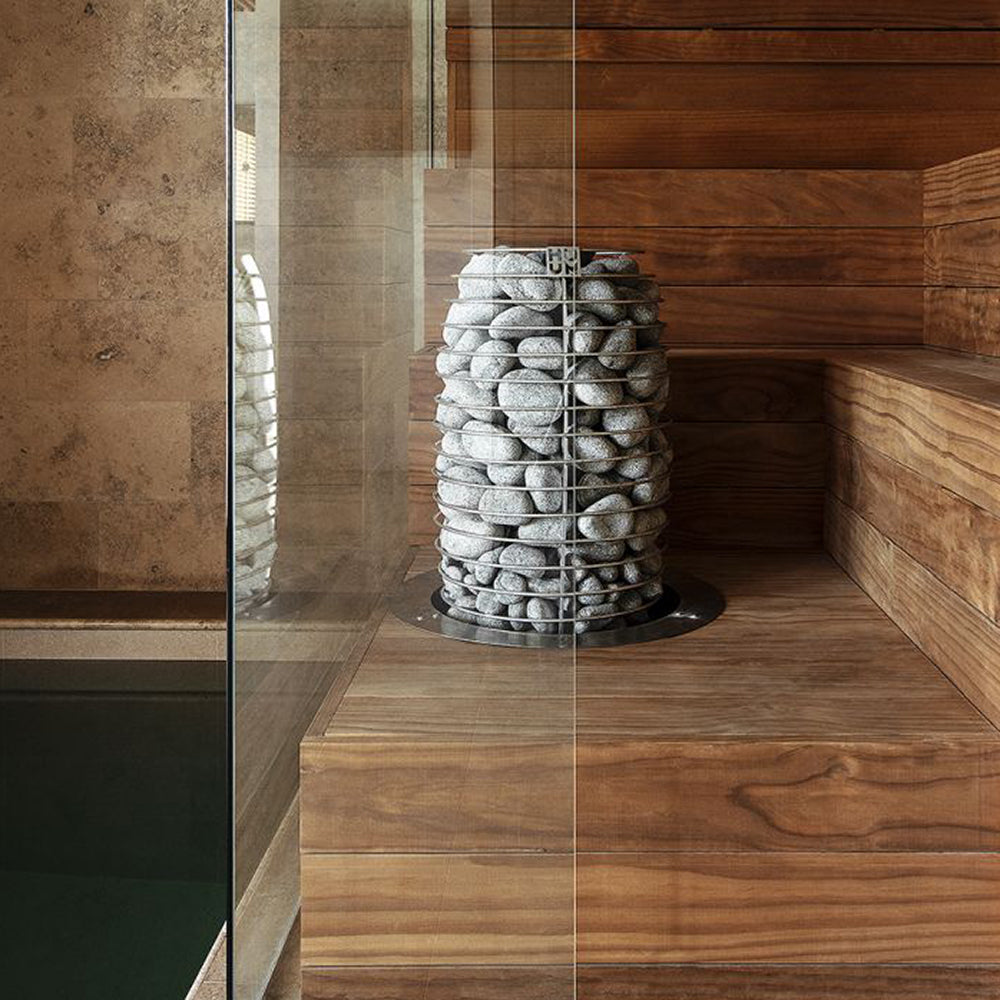 Huum Hive Mini 10.6kW Sauna Heater in a sauna with glass wall