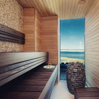 Huum Hive Mini 9kW Sauna Heater in a sauna with sea view window