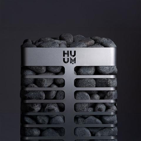 Front view of the Huum Steel Mini 3.5kW Sauna Heater with sauna stones on a dark background