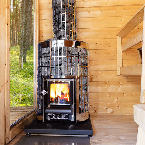 Harvia Cilindro 16 16kW Wood-Burning Sauna Stove in a sauna cabin beside a window