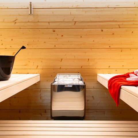 Harvia KIP 6kW Sauna Heater installed in a sauna with red towel