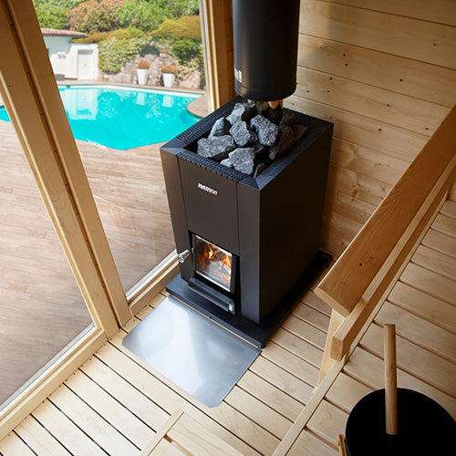 Harvia Linear 18 Compact 14.3kW Wood-Burning Sauna Stove installed in a sauna with a pool view
