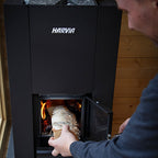 Loading firewood into the Harvia Linear 18 Compact 14.3kW Wood-Burning Sauna Stove
