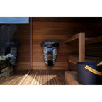 Harvia Spirit 8kW Sauna Heater mounted on a sauna wall with bucket nearby