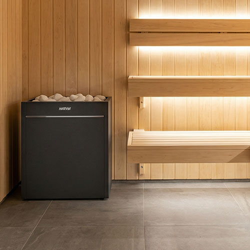 Harvia Virta Pro HL160E 16kW electric sauna heater in a sauna with warm backlit wall