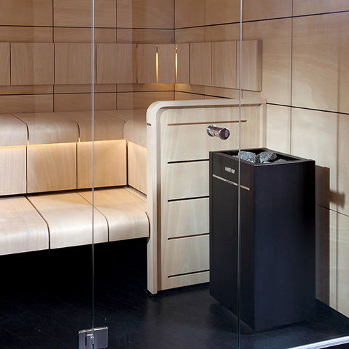 Harvia Virta HL110E 10.5kW Sauna Heater in a sauna with white benches