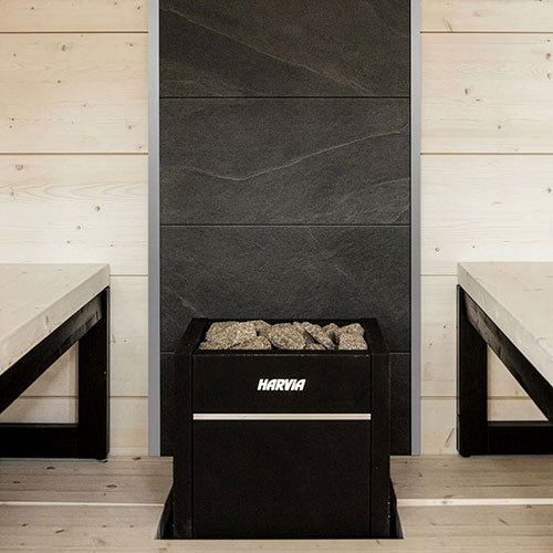 Harvia Virta HL90E 9kW Sauna Heater in a sauna with dark feature wall and wooden benches