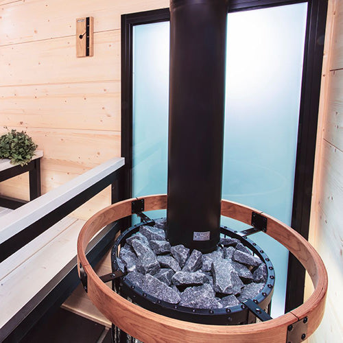Harvia Legend 240 Duo 21kW Wood-Burning Sauna Stove and Fireplace with copper-colored stone ring and chimney pipe in a sauna