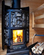 Harvia Legend 240 GreenFlame 15.9kW Wood-Burning Sauna Stove with fire burning and firewood beside it in a sauna