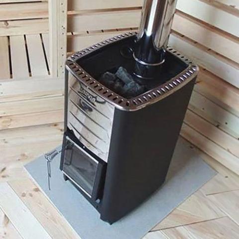 Harvia M3 16.5kW Wood-Burning Sauna Stove on a floor protection plate in a sauna with chimney pipe