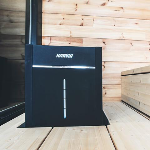 Harvia Virta Combi HL90SA 9kW Sauna Heater and Steamer installed in a sauna with wooden walls