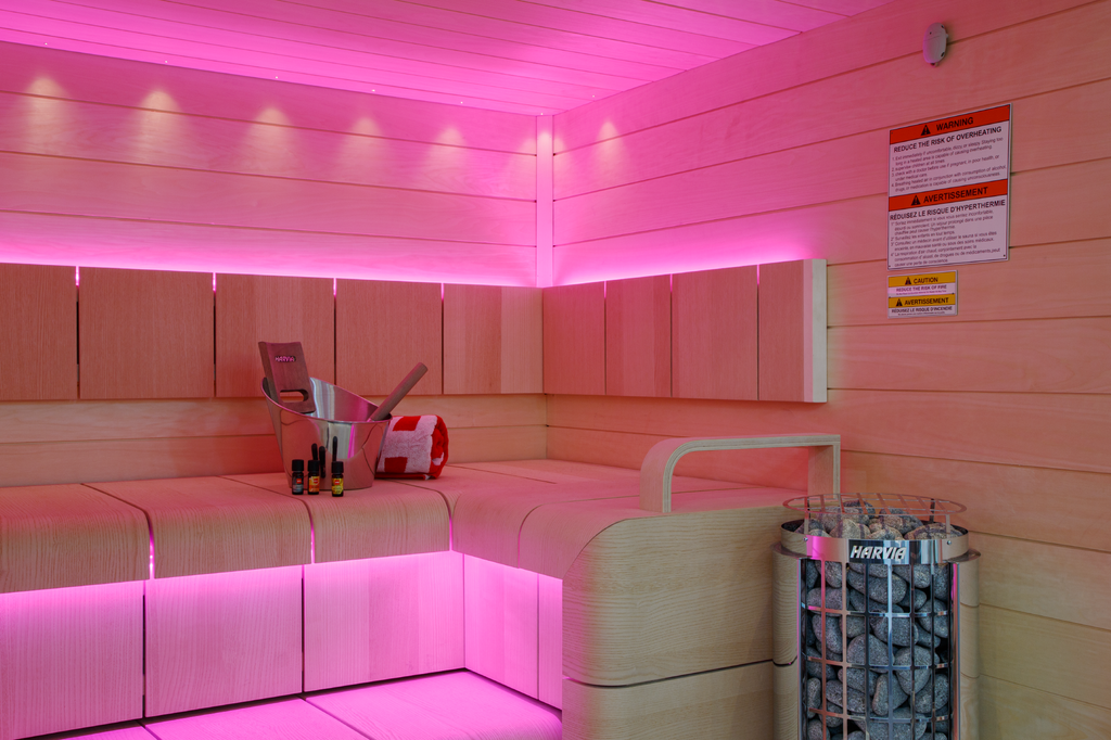 Harvia Cilindro PC110E 10.5kW Sauna Heater in a sauna with pink LED lighting