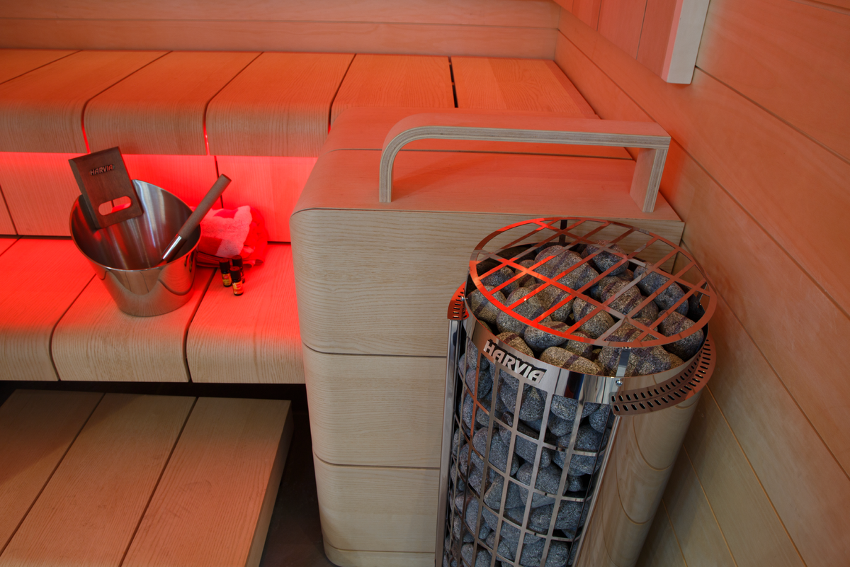 Harvia Cilindro PC90 9kW Sauna Heater in a sauna with orange mood lighting