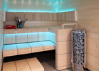 Harvia Cilindro PC90 9kW Sauna Heater in a sauna with blue accent lighting and white benches