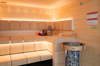 Harvia Cilindro PC60E 6kW Sauna Heater in a sauna with safety railing