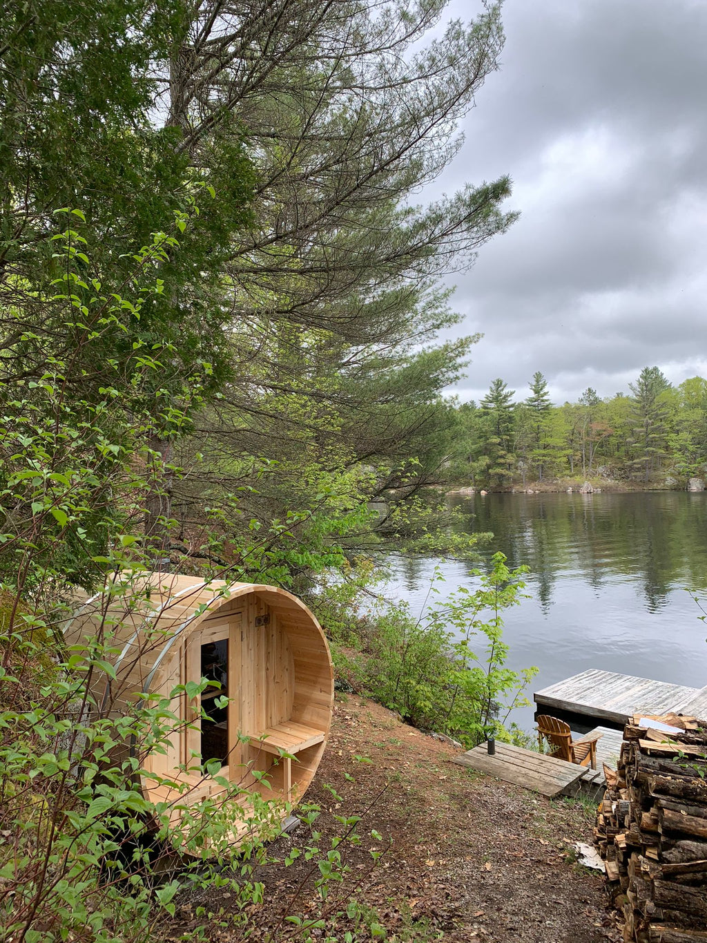 Dundalk CT Serenity 5-Person Outdoor Barrel Sauna beside a forest lake