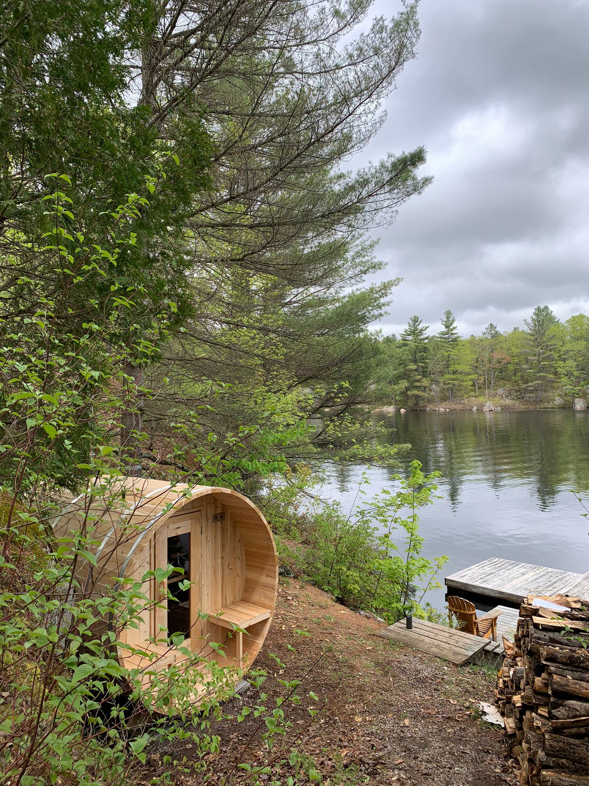 Dundalk CT Serenity 5-Person Outdoor Barrel Sauna beside a forest lake