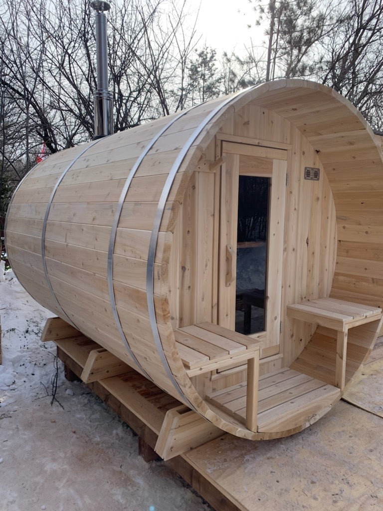 Side view of the Dundalk CT Serenity 5-Person Outdoor Barrel Sauna in winter