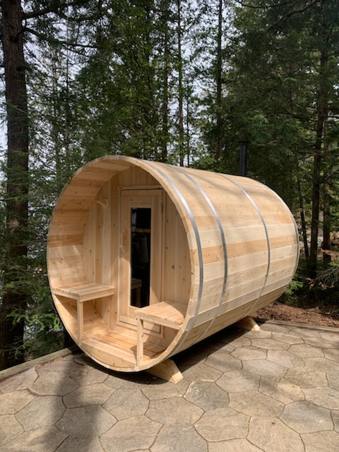 Front view of the Dundalk CT Serenity 5-Person Outdoor Barrel Sauna on a gravel pad