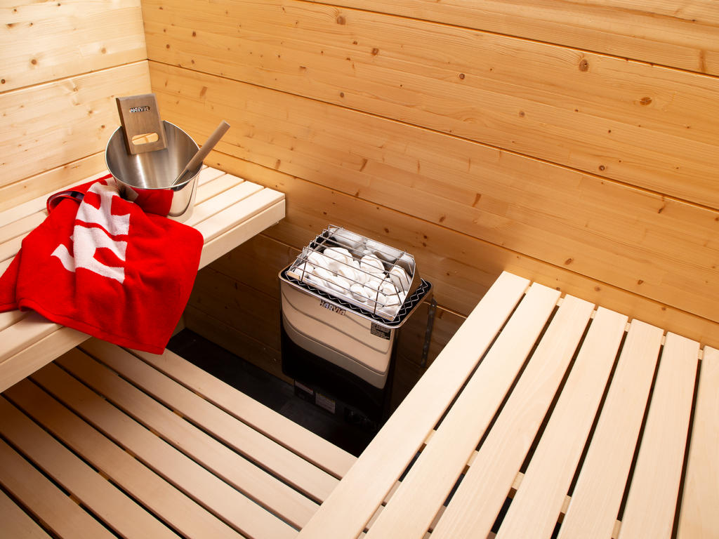 Harvia KIP 8kW Sauna Heater in a sauna with red towel on the bench