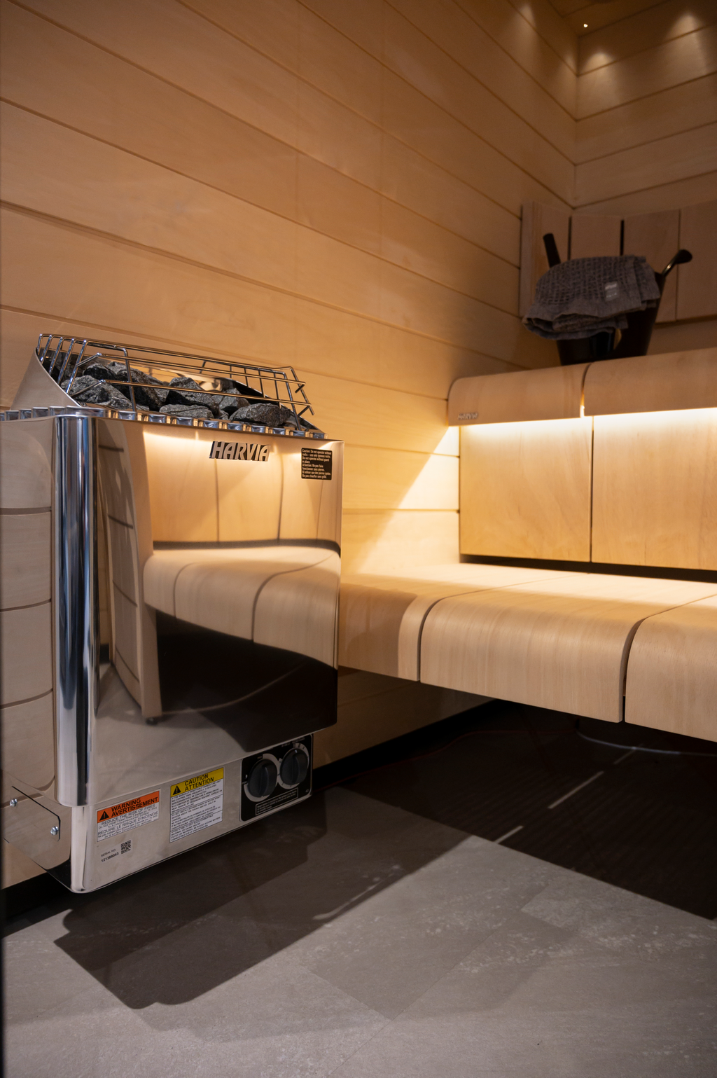 Harvia KIP 8kW Sauna Heater installed in a sauna with lighted benches