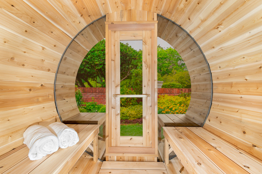 Interior of the Dundalk CT 6-Person Outdoor Barrel Sauna with Half-Moon Windows looking toward the door and half-moon window