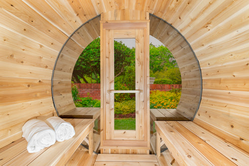 Interior of the Dundalk CT 6-Person Outdoor Barrel Sauna with Half-Moon Windows looking toward the door and half-moon window